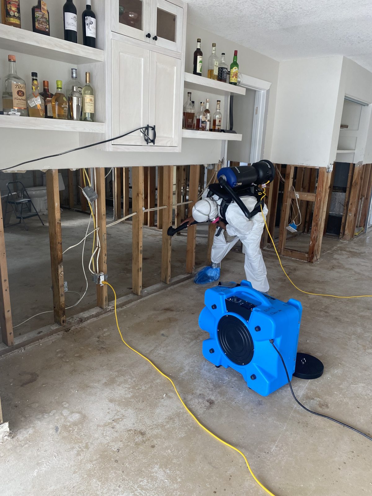 AIM technician performing safe mold remediation inside a sealed containment area in a Wesley Chapel home
